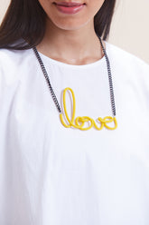 Yellow leather women's short with distinctive love-link metal necklace